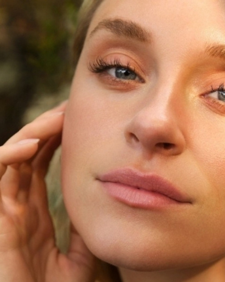 Julaine skin rejuvenation model touching her firmer face