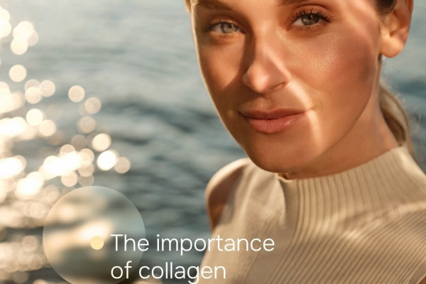 Photo of Julaine PLLA model looking directly into camera, smiling with water in the background